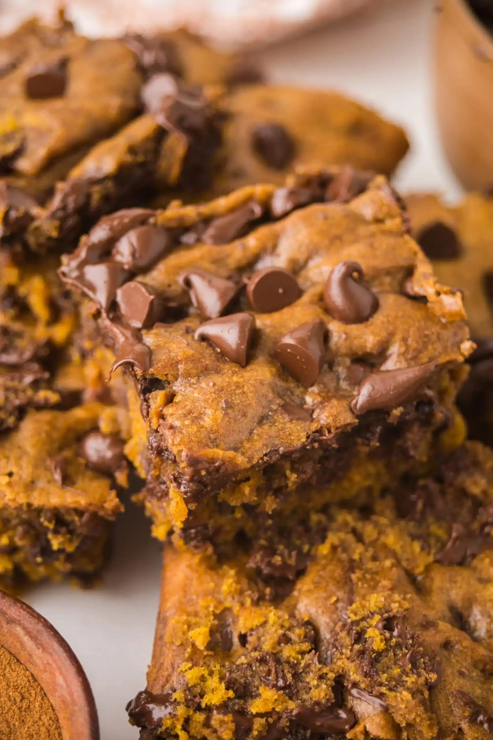 Brown butter pumpkin chocolate chip bars topped with warm chocolate chips